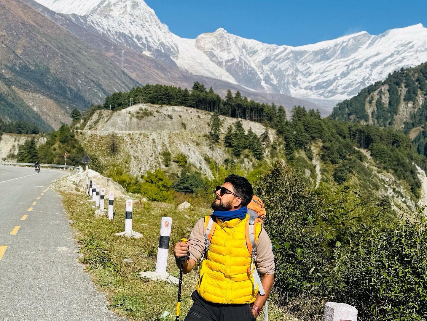 The founder of Reet Trails with a guest in a marigold garden, Himalayan peaks behind
